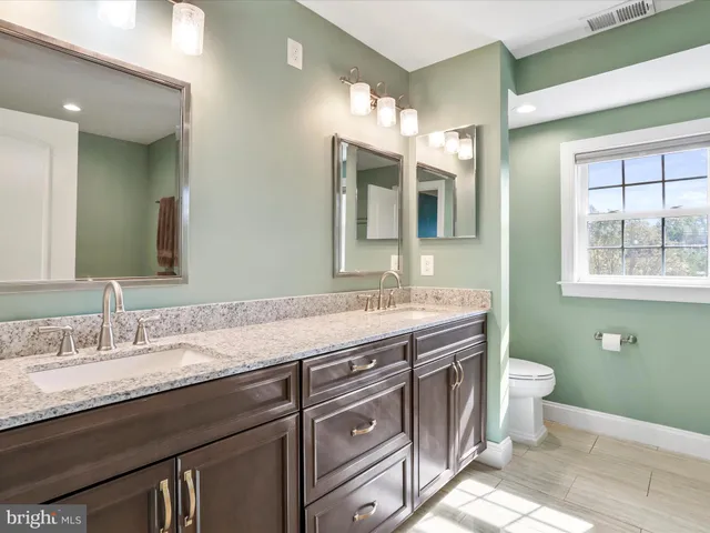 a bedroom with a large bed and couches