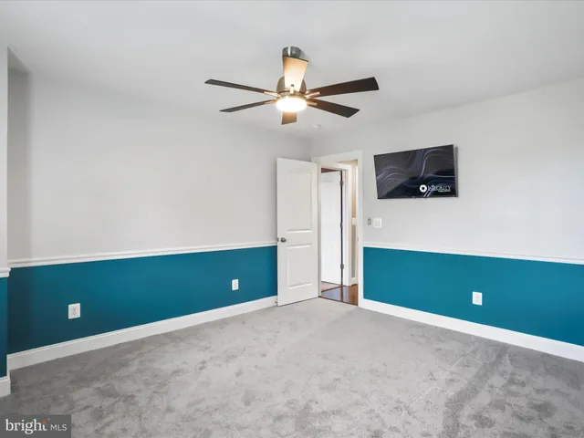 a view of a room with wooden floor and staircase