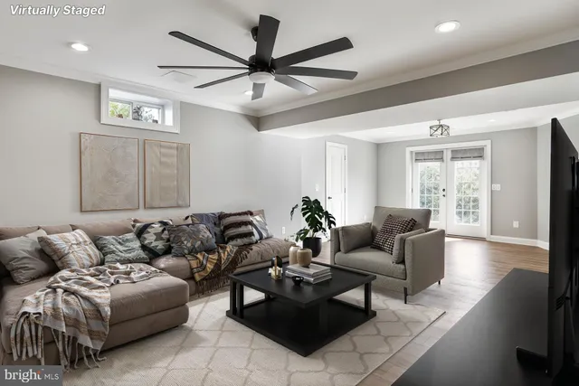 a view of a room with wooden floor and fan