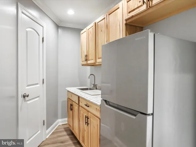 a front view of a house with swimming pool and green space