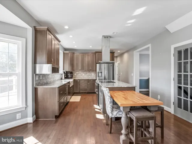 a kitchen with granite countertop a sink a window and cabinets