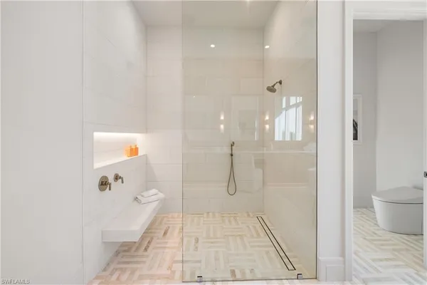 a bathroom with a glass shower door