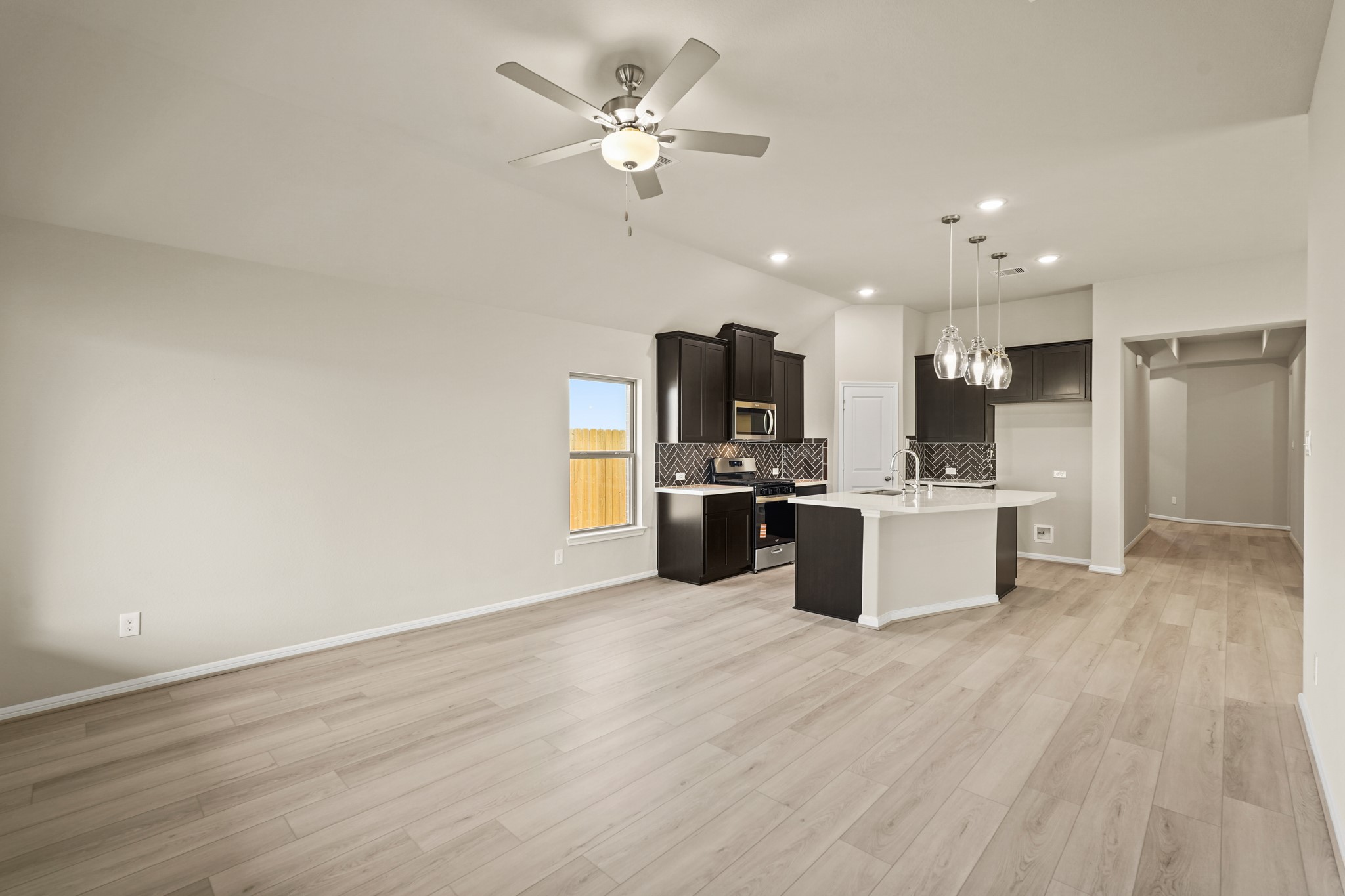 26530 Jolly Prairie Drive Hockley, TX 77447 - Photo 13 of 36 a large kitchen with kitchen island a sink stainless steel appliances and cabinets