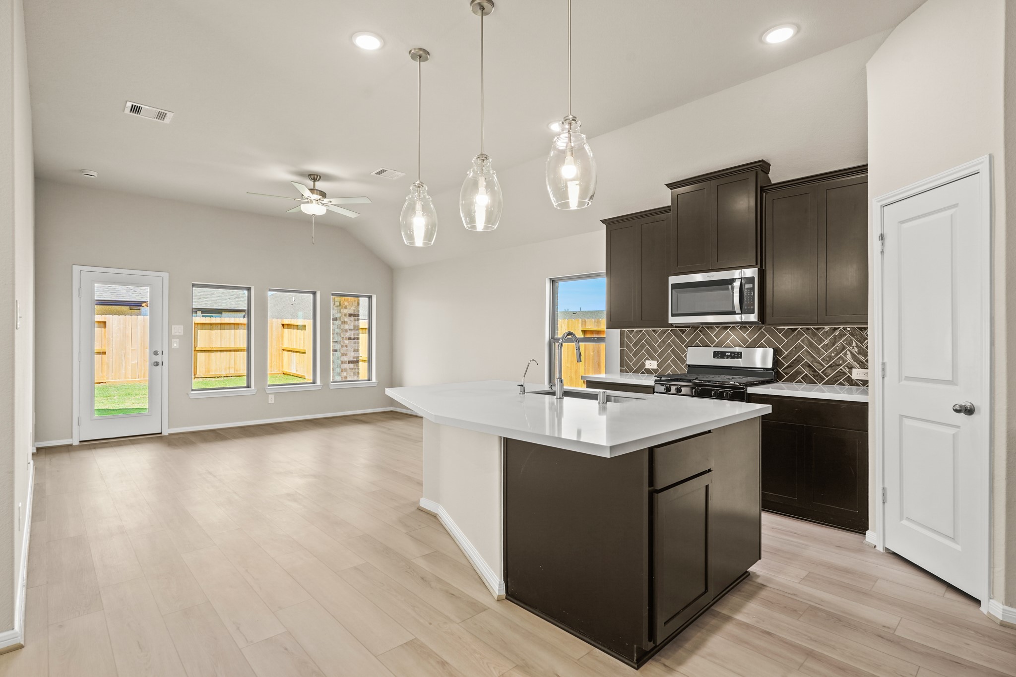 26530 Jolly Prairie Drive Hockley, TX 77447 - Photo 3 of 36 a kitchen with kitchen island granite countertop a sink appliances and cabinets