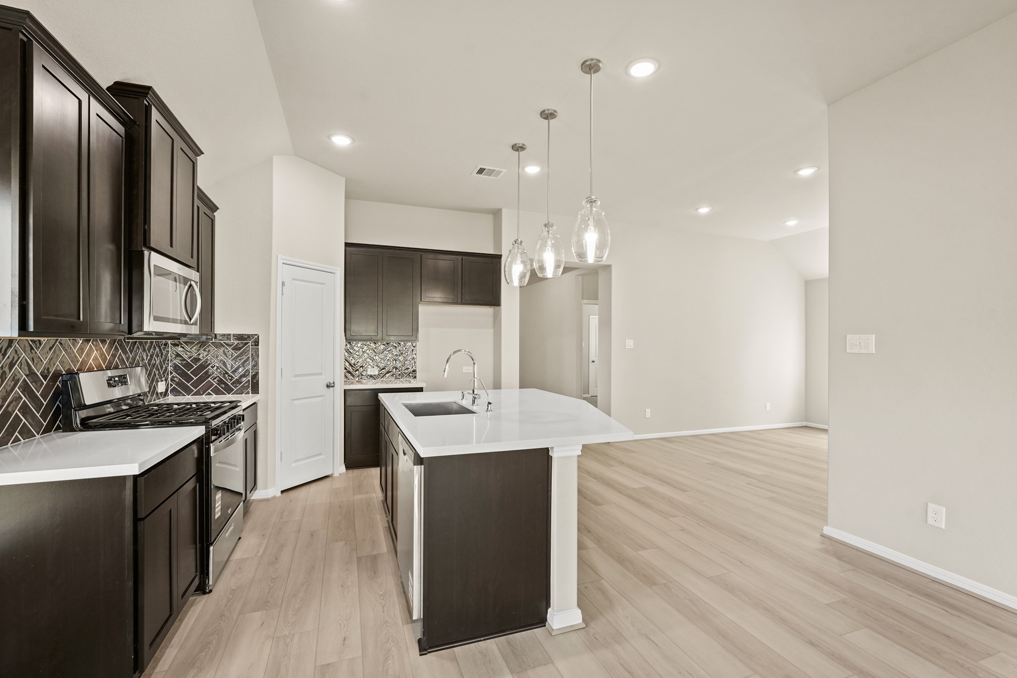 26530 Jolly Prairie Drive Hockley, TX 77447 - Photo 6 of 36 a large kitchen with a sink and stainless steel appliances