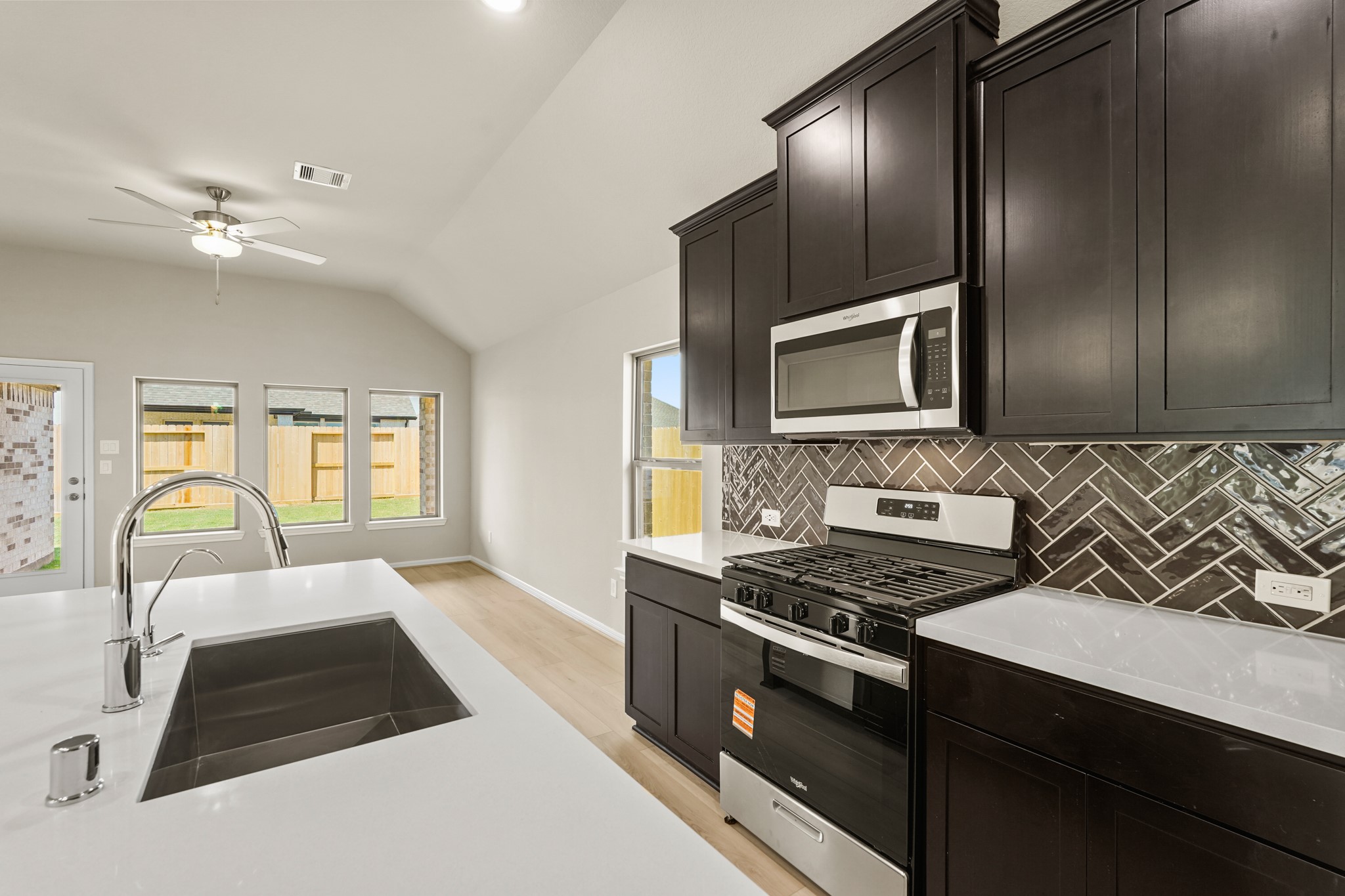 26530 Jolly Prairie Drive Hockley, TX 77447 - Photo 7 of 36 a kitchen with a stove a sink and a microwave