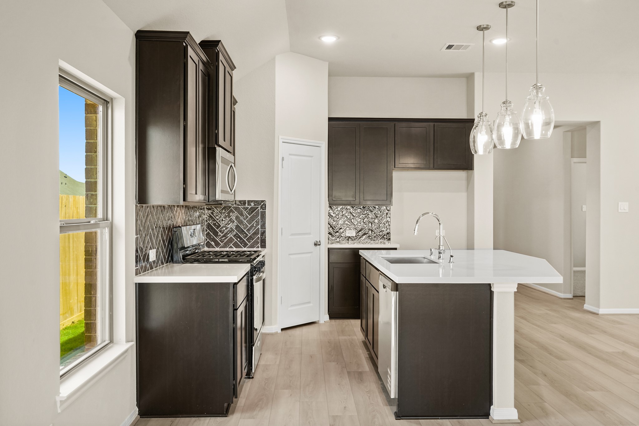 26530 Jolly Prairie Drive Hockley, TX 77447 - Photo 8 of 36 a kitchen with stainless steel appliances kitchen island granite countertop a sink a stove and a refrigerator