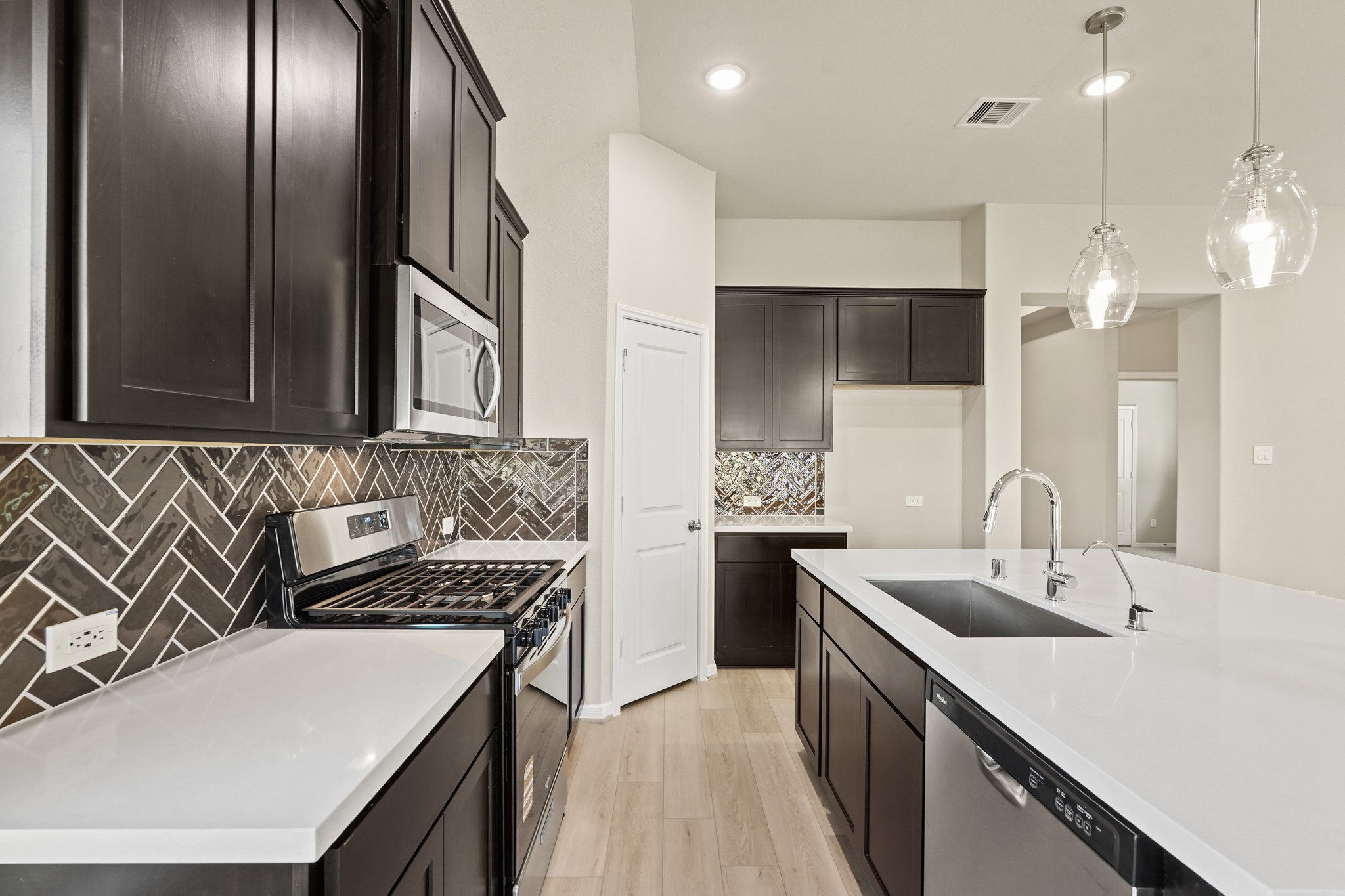 26530 Jolly Prairie Drive Hockley, TX 77447 - Photo 9 of 36 a kitchen with a sink and a refrigerator