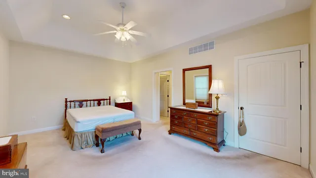 a bedroom with a large bed and a chandelier