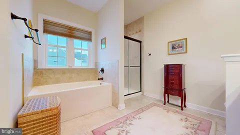a bathroom with a granite countertop sink a toilet and shower
