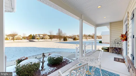 an aerial view of a house with swimming pool and a yard