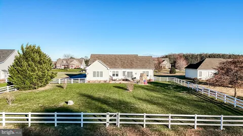 a view of a house with table and chairs in patio