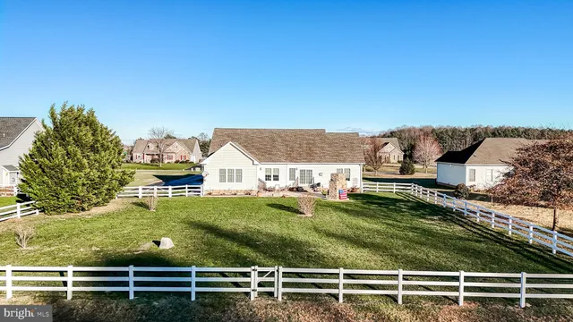 a view of a house with table and chairs in patio
