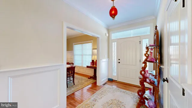 a living room with furniture kitchen view and a flat screen tv