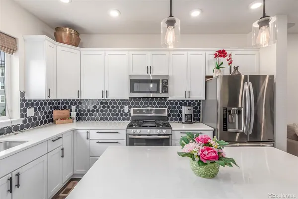 a kitchen with refrigerator and cabinets