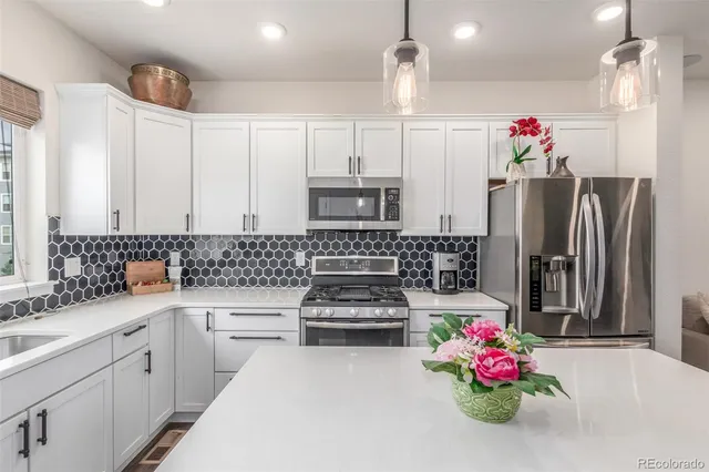 a kitchen with refrigerator and cabinets
