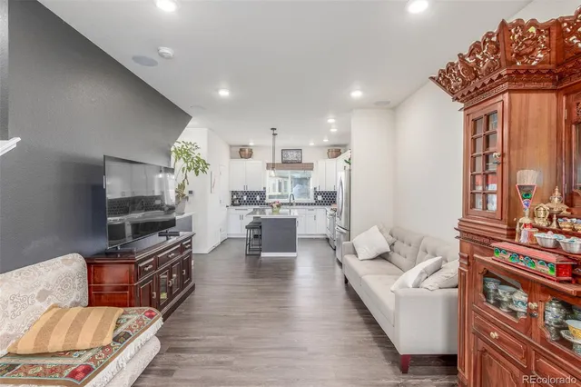a living room with fireplace furniture and a flat screen tv
