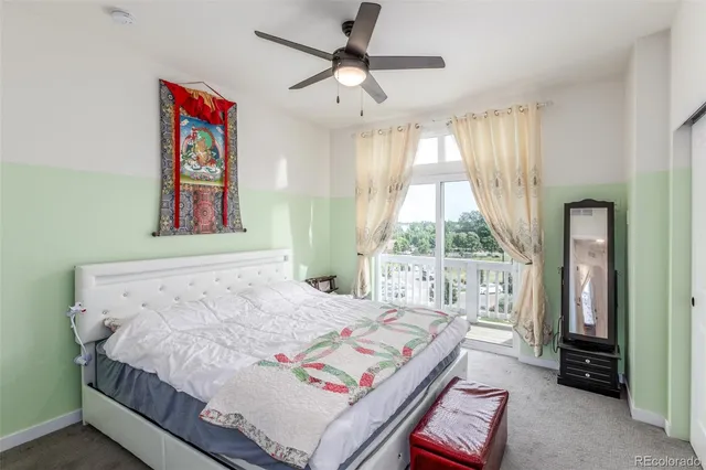 a bedroom with a bed and a large window