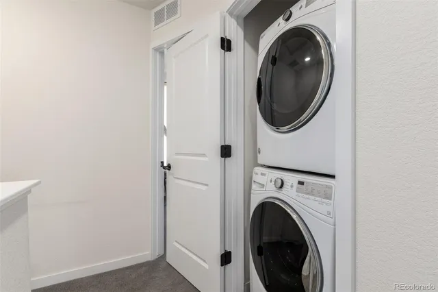 a view of a hallway with washer and dryer