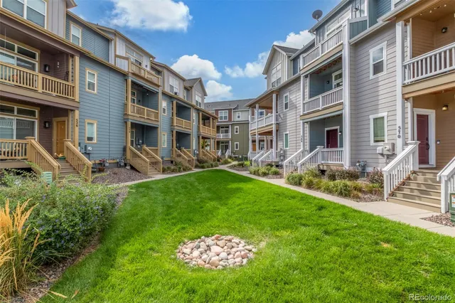 a row of table and chairs in the yard