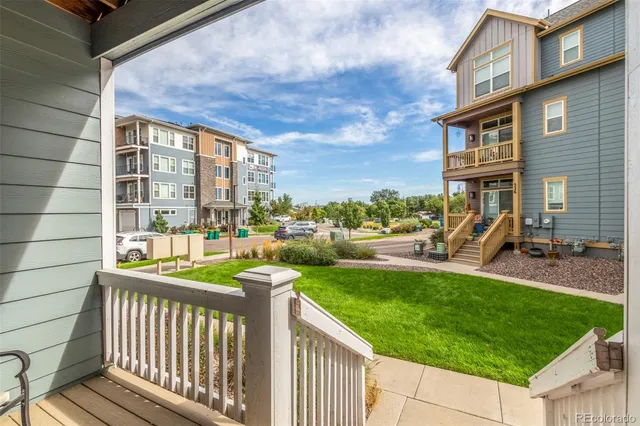 a city view with tall buildings and a yard
