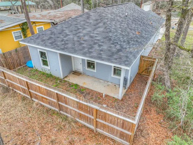 a view of a house with backyard and deck