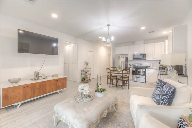 a large kitchen with kitchen island a large counter space a sink stainless steel appliances and cabinets