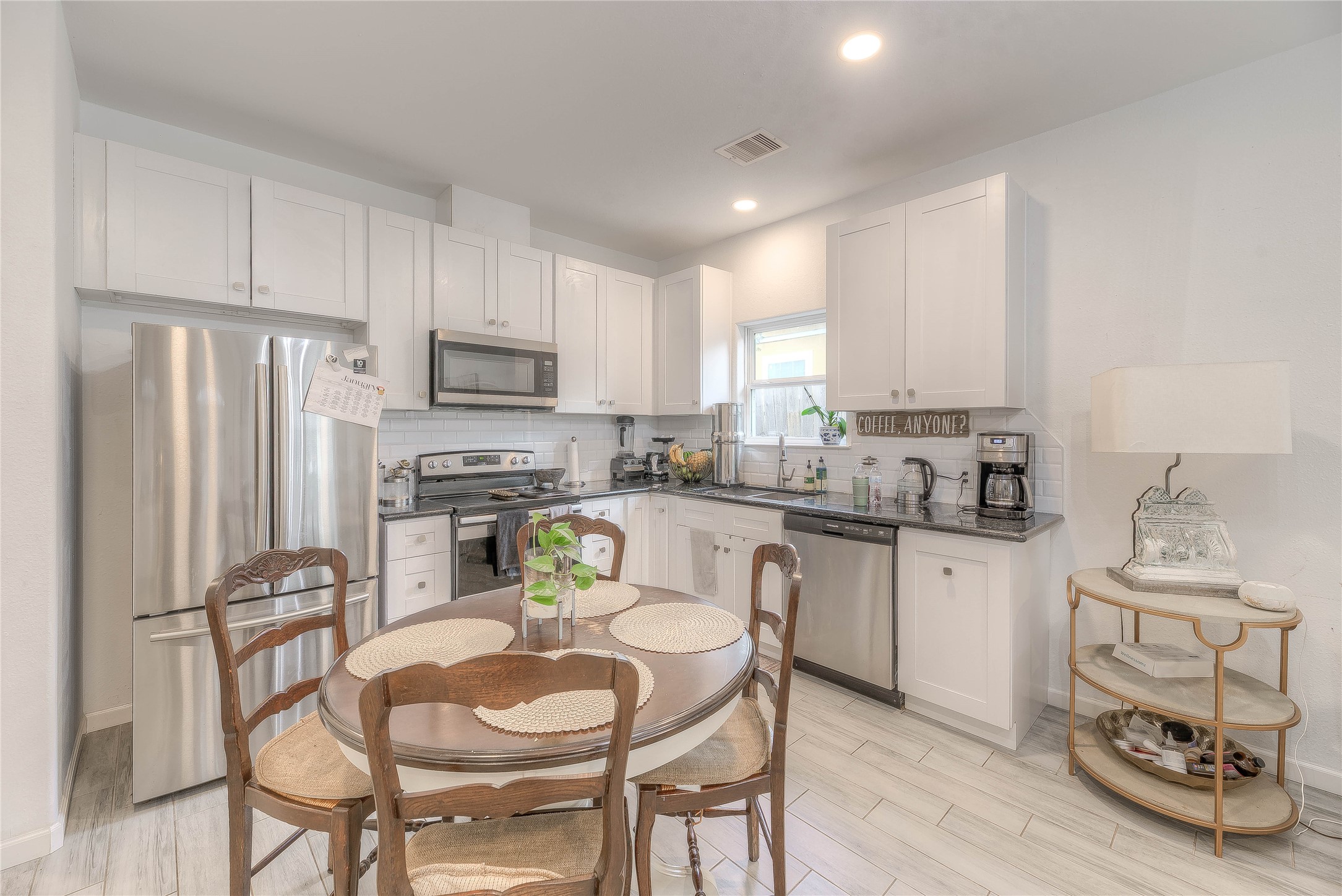 627 Pinewood Drive Trinity, TX 75862 - Photo 5 of 36 a kitchen with stainless steel appliances granite countertop white cabinets a refrigerator and a stove top oven