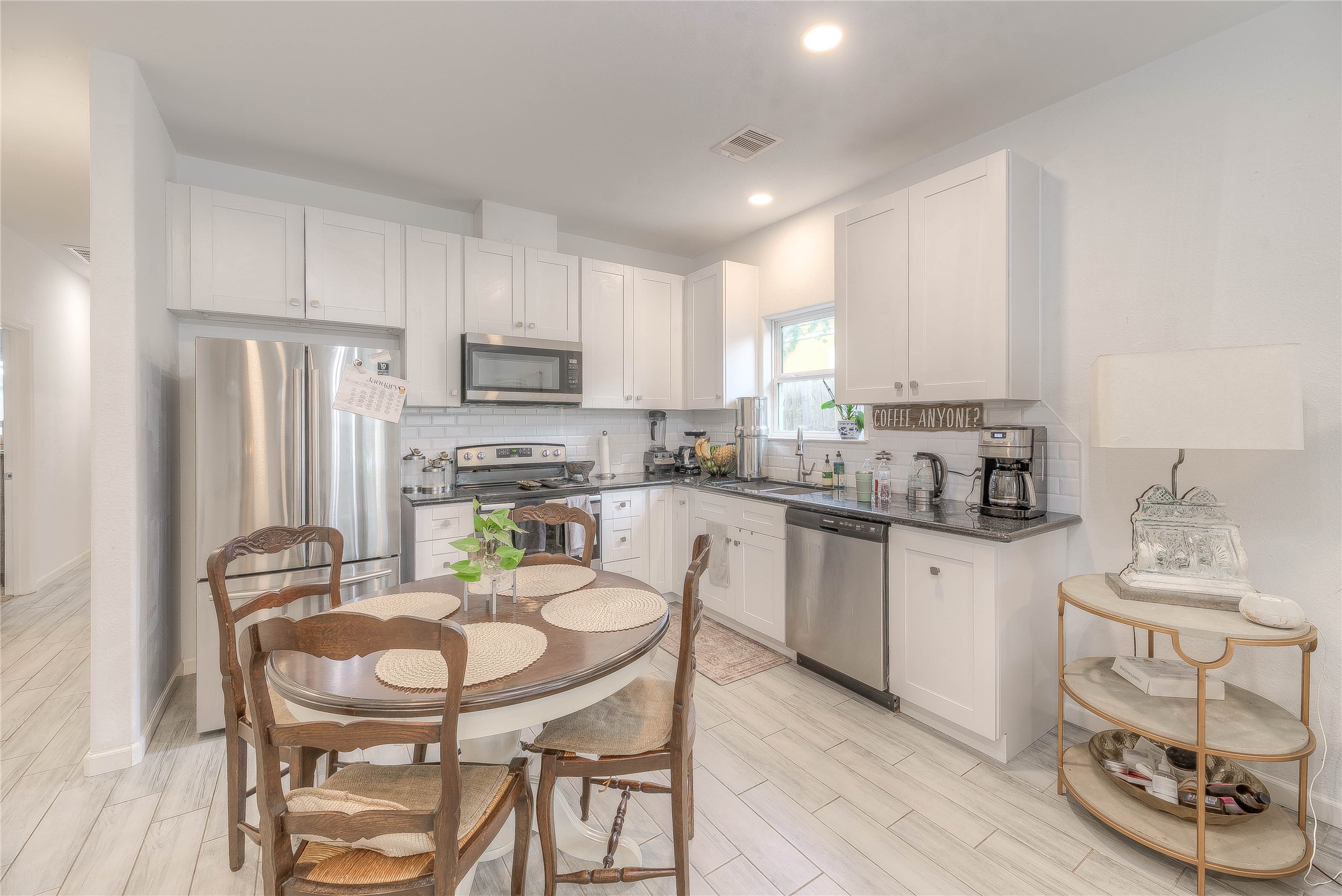 627 Pinewood Drive Trinity, TX 75862 - Photo 6 of 36 a kitchen with stainless steel appliances granite countertop a dining table chairs refrigerator sink and cabinets