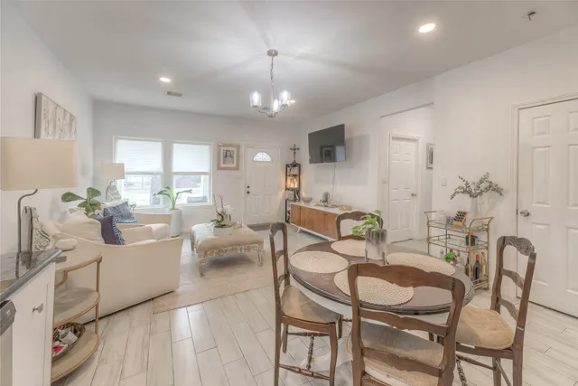 a living room with furniture and a chandelier