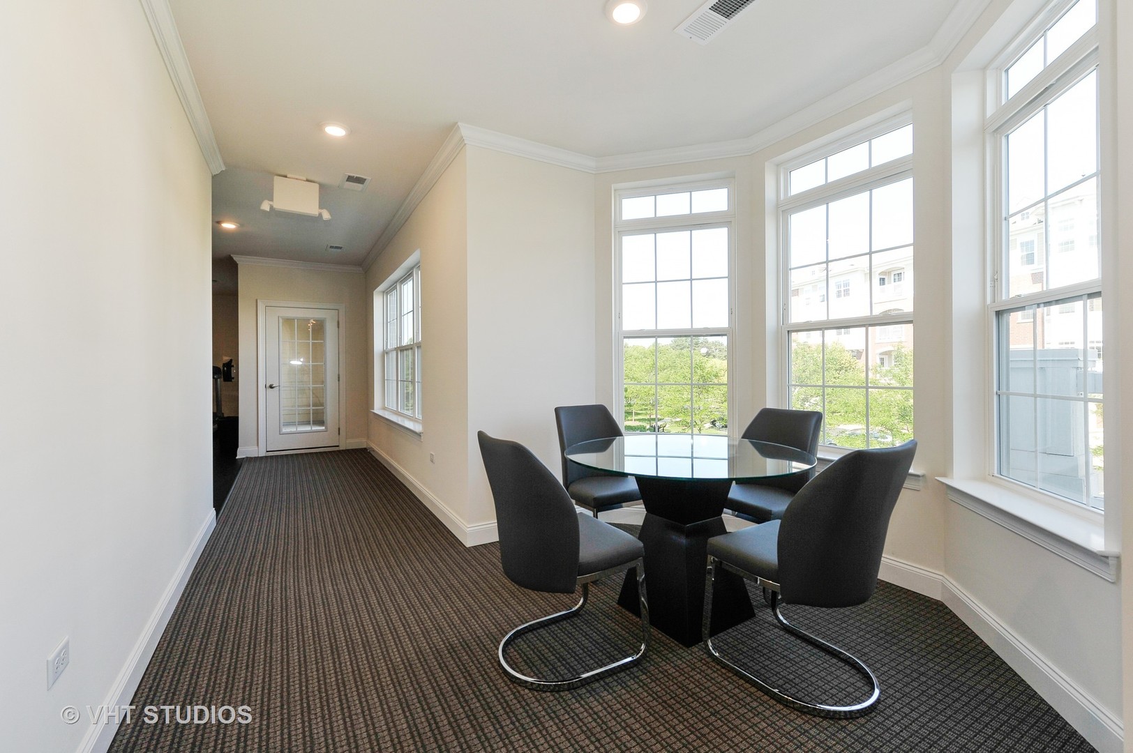 2701 Commons Drive, Unit 207 Glenview, IL 60026 - Photo 16 of 23 a view of a dining room with furniture wooden floor and windows