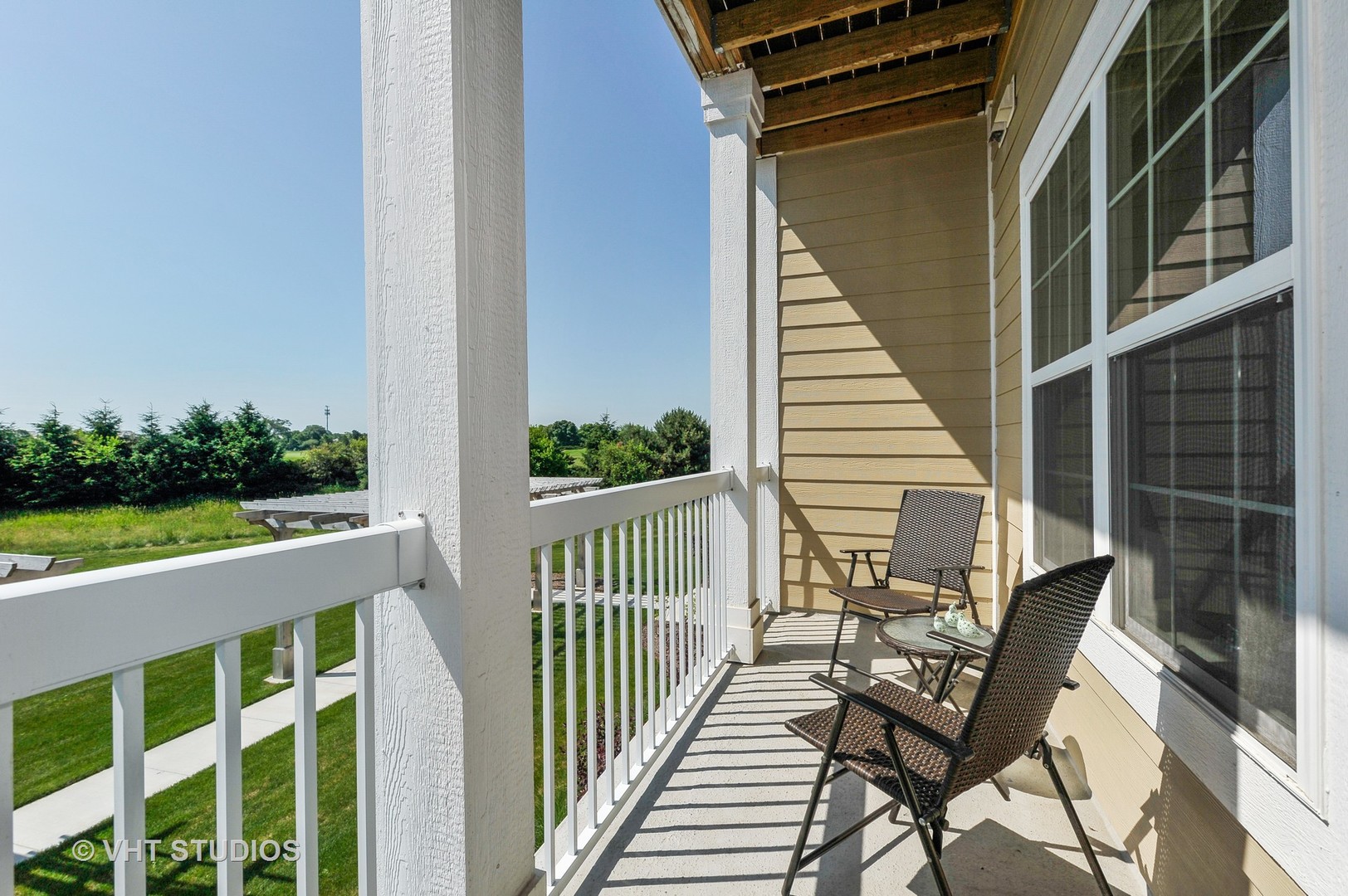 2701 Commons Drive, Unit 207 Glenview, IL 60026 - Photo 18 of 23 a view of balcony with wooden floor and outdoor seating