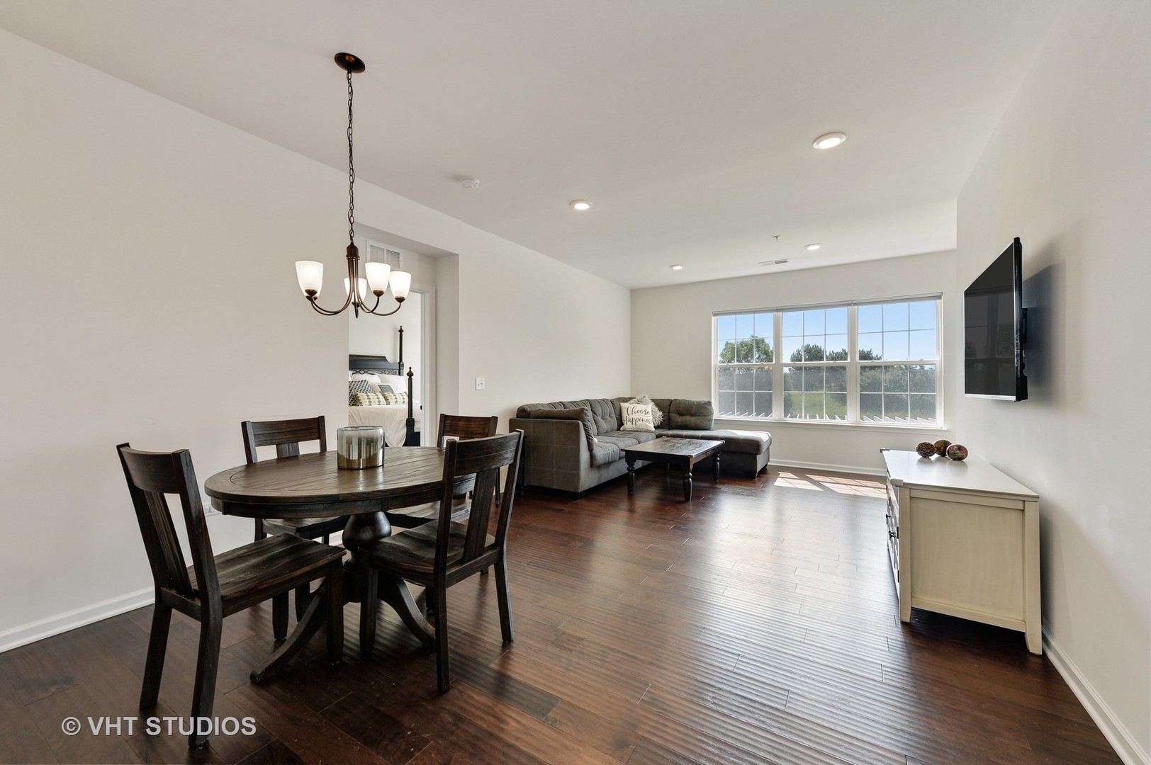 2701 Commons Drive, Unit 207 Glenview, IL 60026 - Photo 4 of 23 a view of a dining room with furniture window and wooden floor