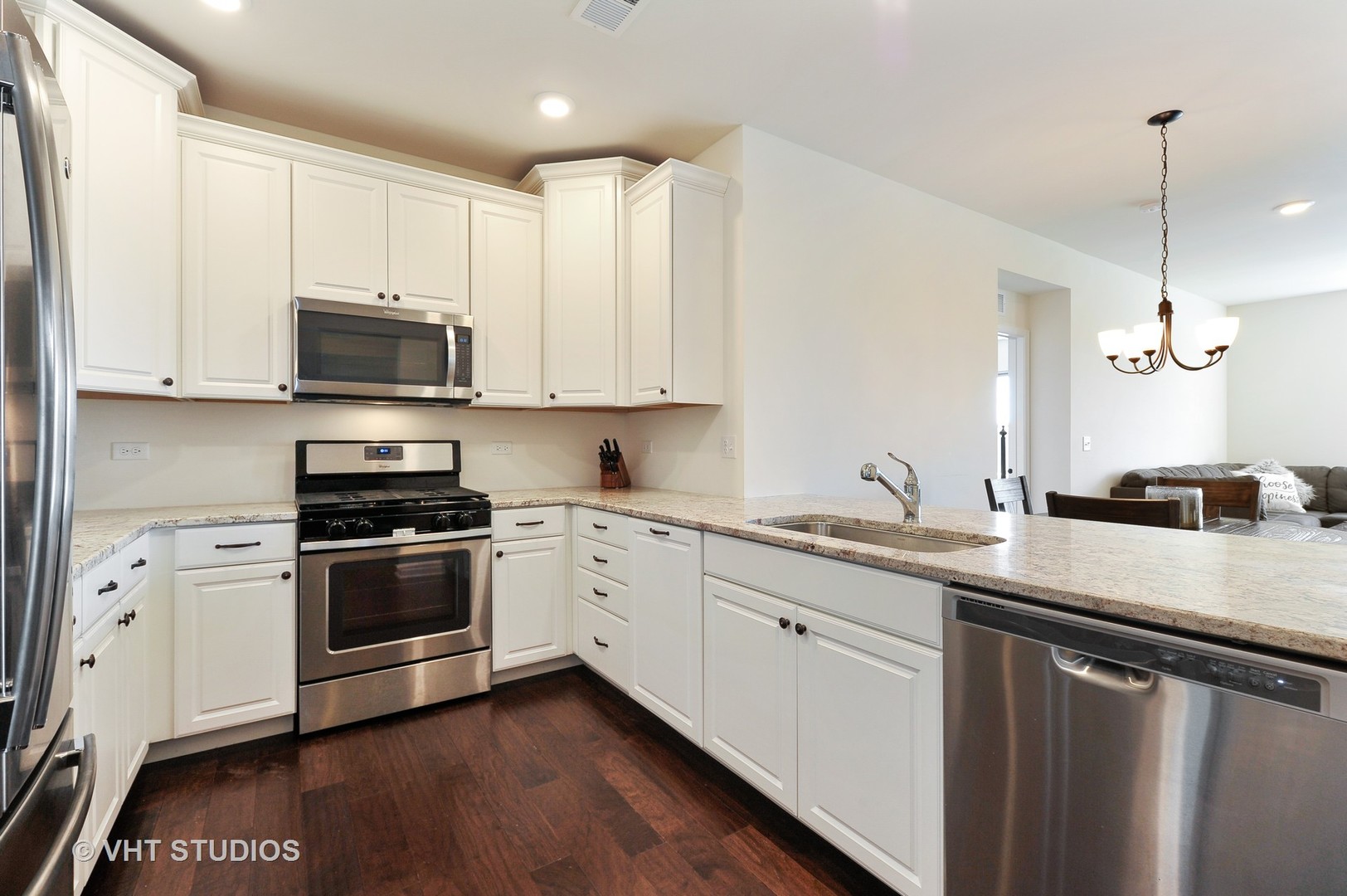 2701 Commons Drive, Unit 207 Glenview, IL 60026 - Photo 6 of 23 a kitchen with stainless steel appliances granite countertop a sink a stove a microwave and cabinets