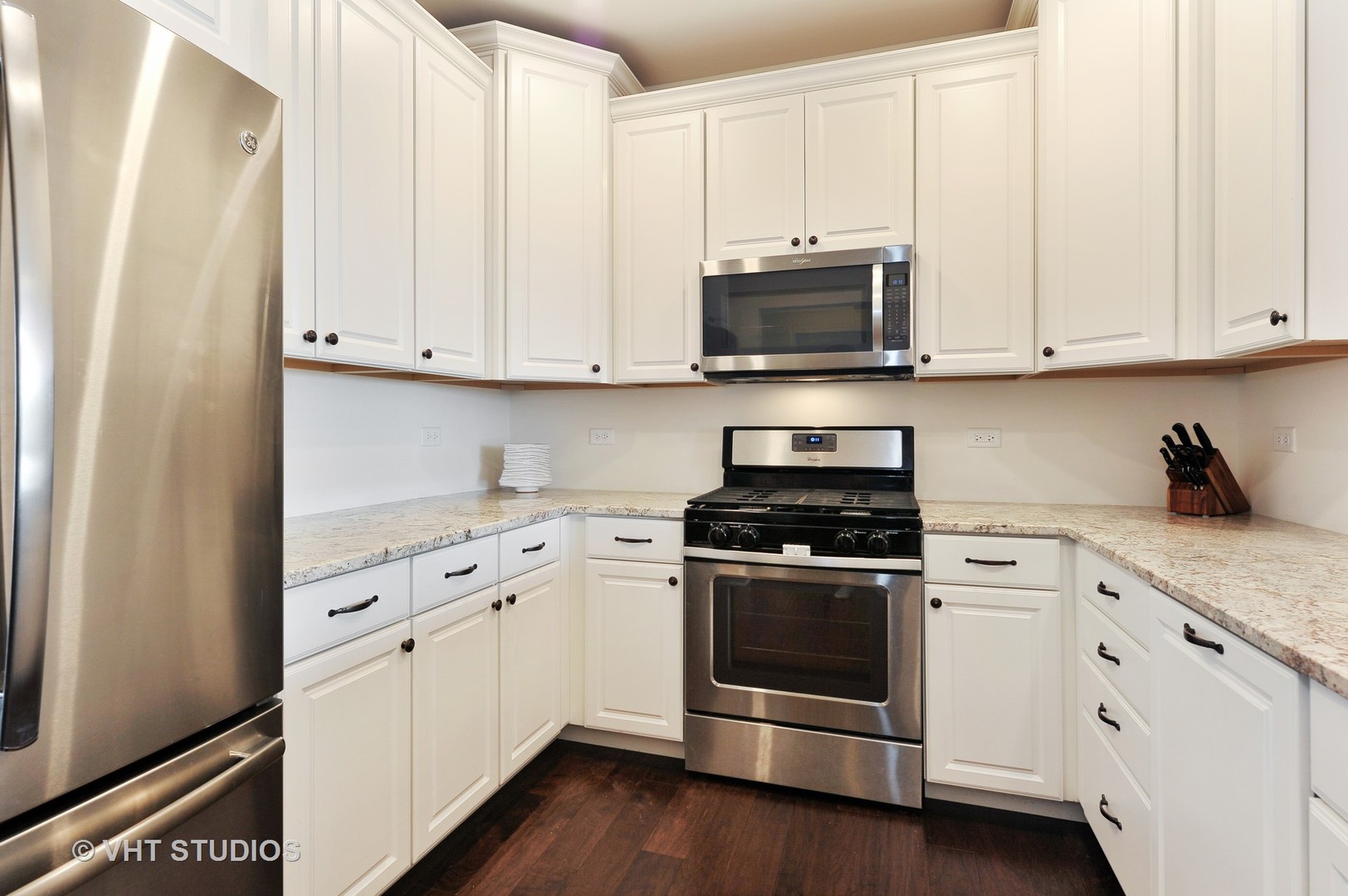 2701 Commons Drive, Unit 207 Glenview, IL 60026 - Photo 7 of 23 a kitchen with stainless steel appliances granite countertop white cabinets and a stove top oven