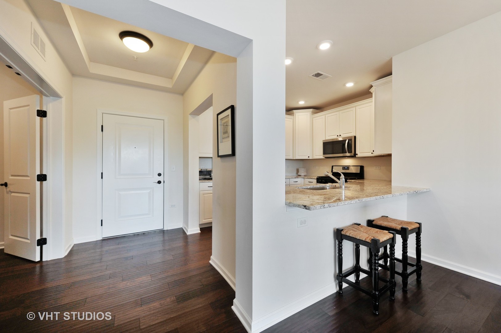 2701 Commons Drive, Unit 207 Glenview, IL 60026 - Photo 8 of 23 a view of kitchen with cabinets and wooden floor