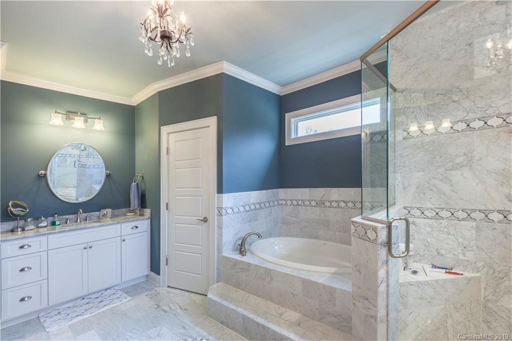 1911 Truman Road Charlotte, NC 28205 - Photo 17 of 30 a bathroom with a double vanity sink mirror and bathtub