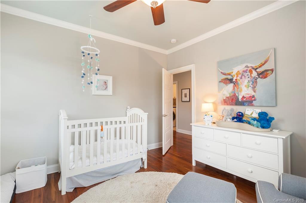1911 Truman Road Charlotte, NC 28205 - Photo 20 of 30 a bedroom with a baby bed a couch and a window