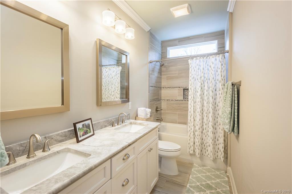 1911 Truman Road Charlotte, NC 28205 - Photo 25 of 30 a bathroom with a granite countertop sink toilet and shower