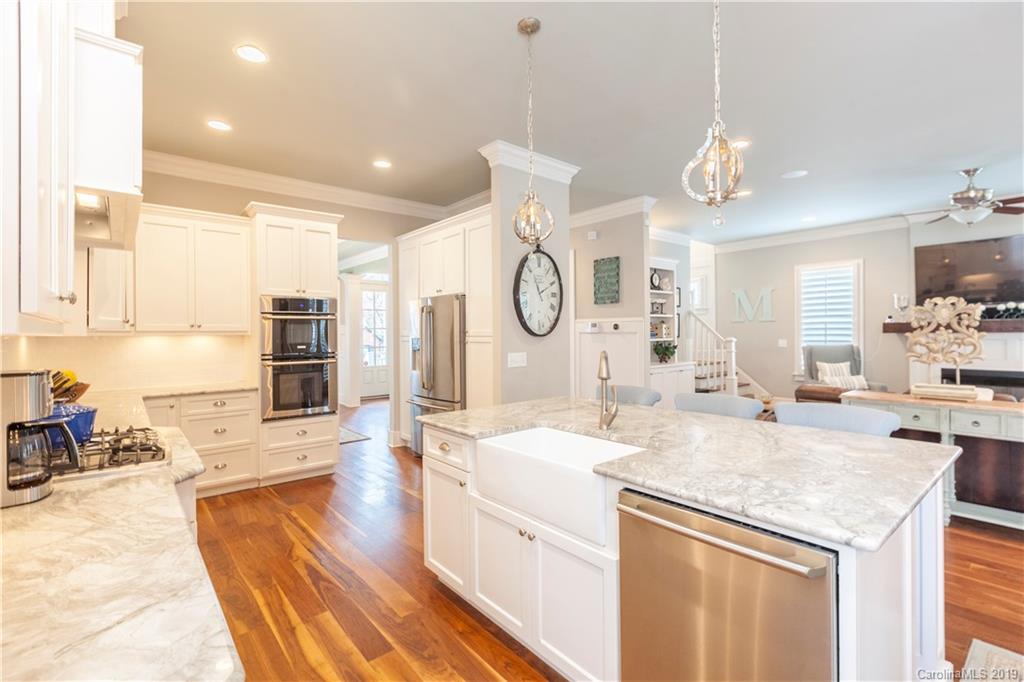 1911 Truman Road Charlotte, NC 28205 - Photo 5 of 30 a large kitchen with kitchen island granite countertop a sink and cabinets