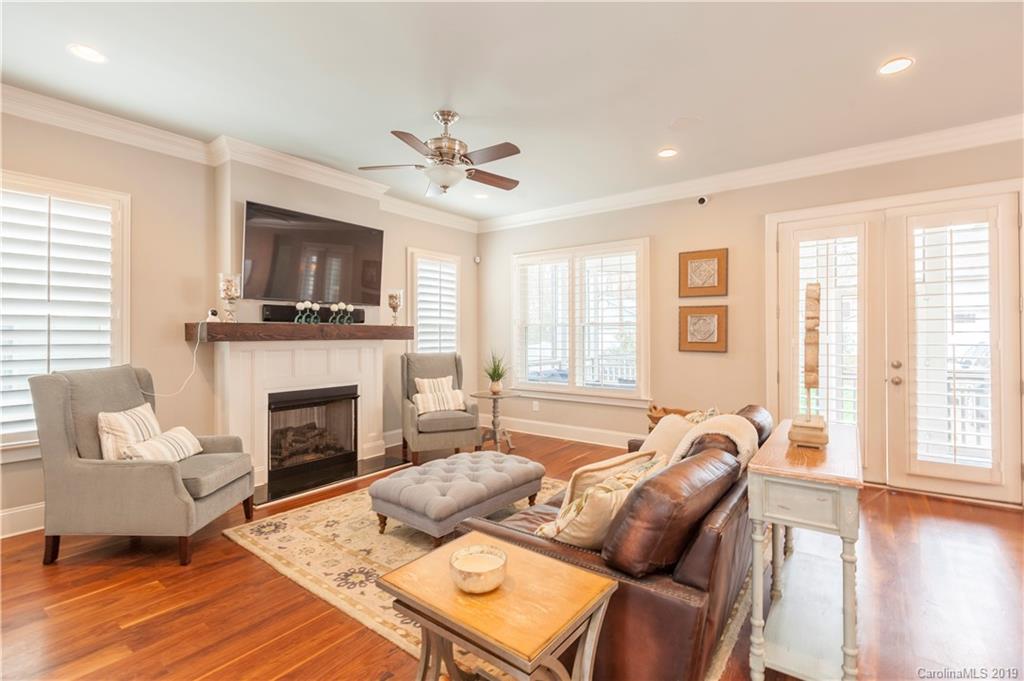 1911 Truman Road Charlotte, NC 28205 - Photo 6 of 30 a living room with furniture a fireplace and a flat screen tv