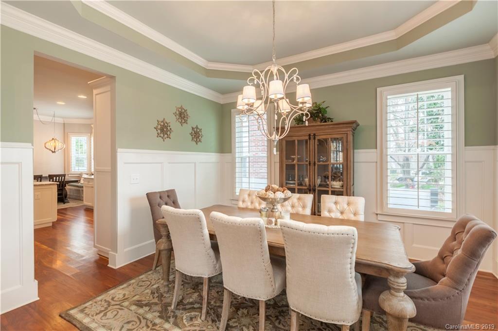 1911 Truman Road Charlotte, NC 28205 - Photo 9 of 30 a dining room with furniture wooden floor a chandelier and a rug