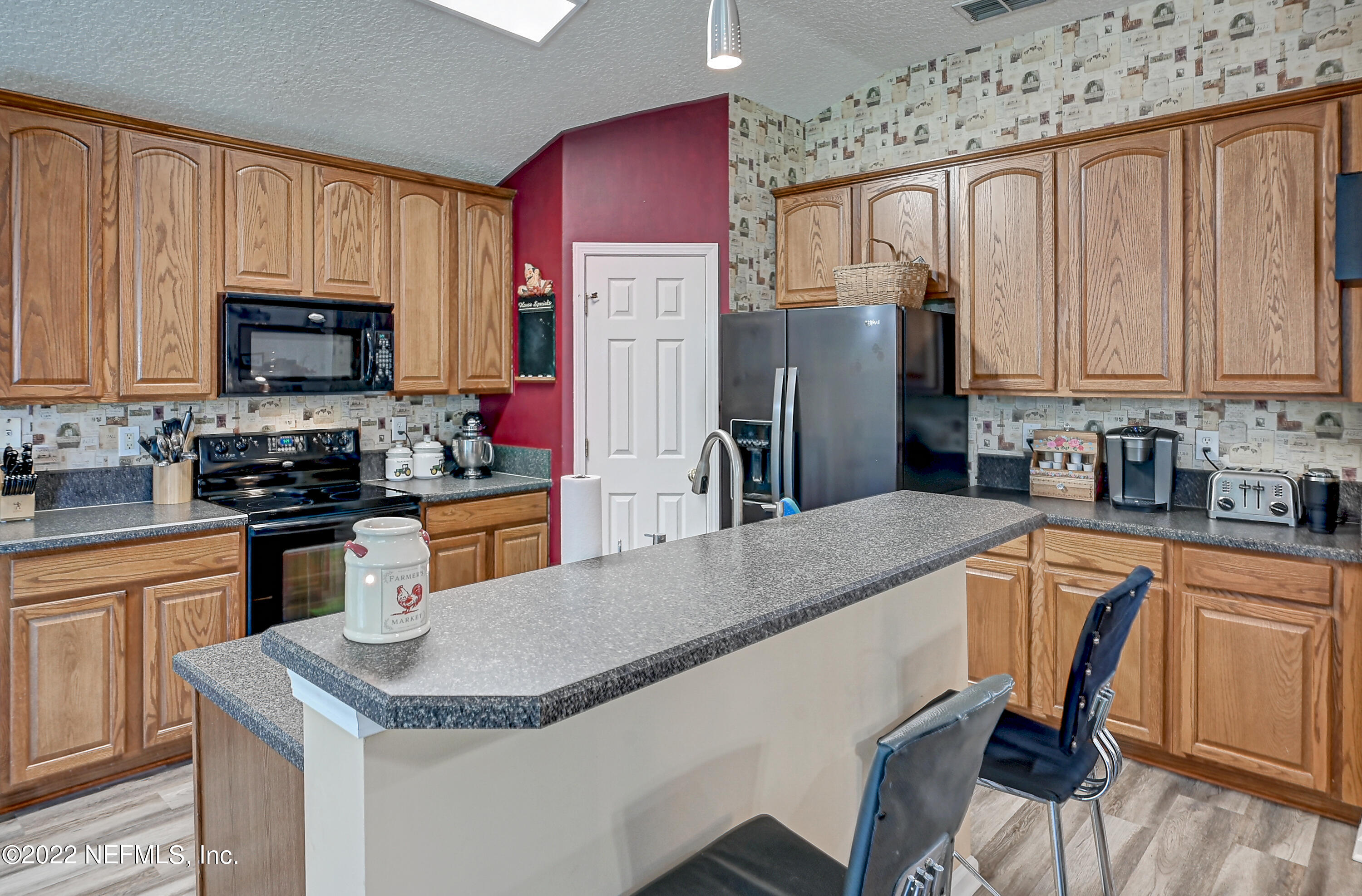 852 Crystal Spring Way St. Augustine, FL 32092 - Photo 11 of 28 a kitchen with stainless steel appliances granite countertop a refrigerator stove microwave sink and cabinets