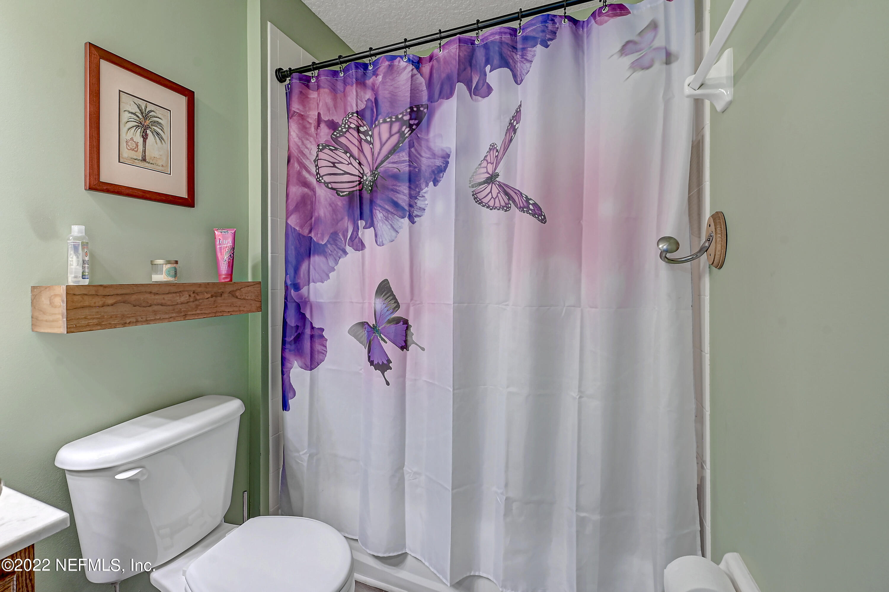 852 Crystal Spring Way St. Augustine, FL 32092 - Photo 24 of 28 a white toilet sitting next to a shower curtain