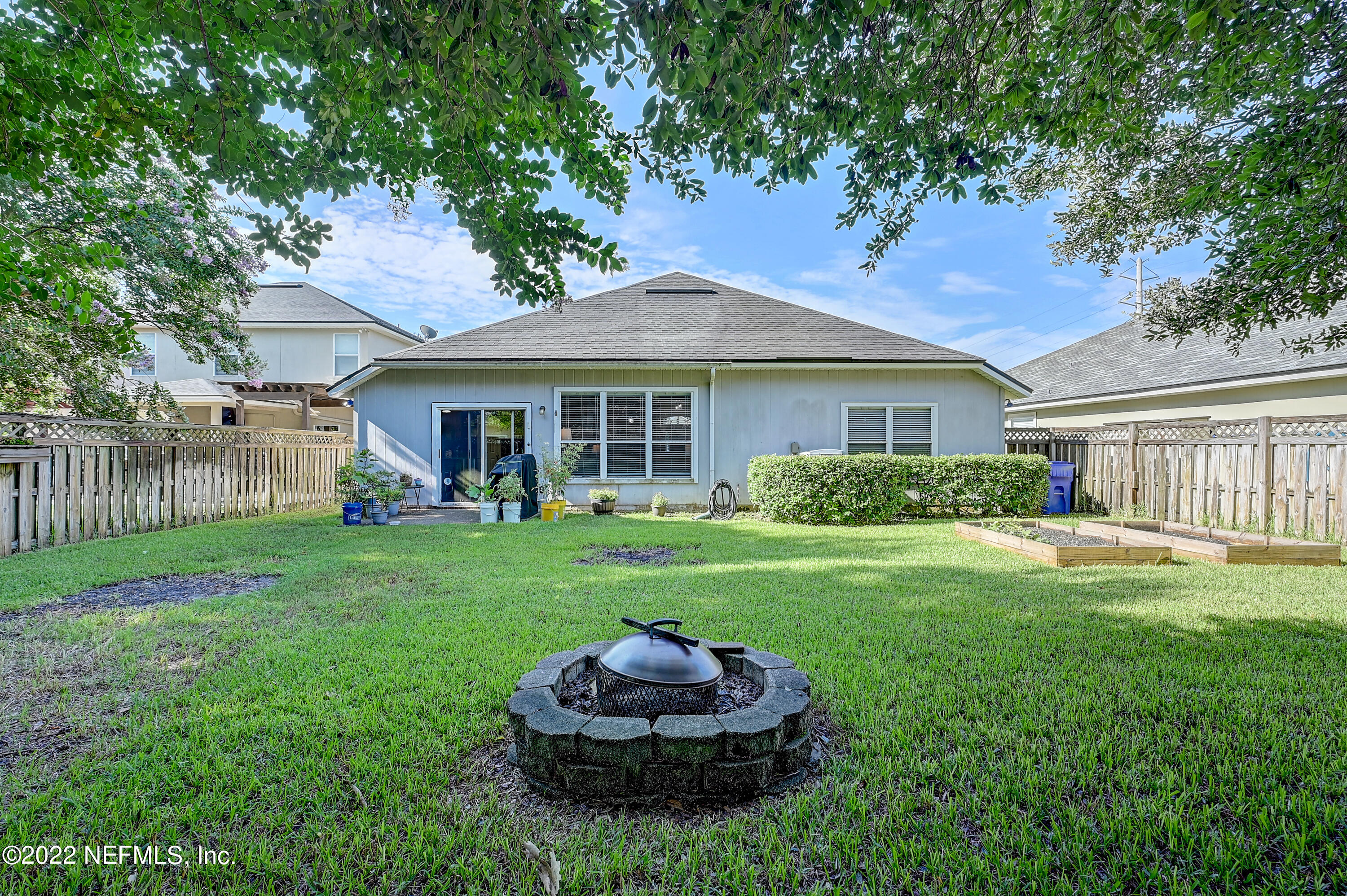 852 Crystal Spring Way St. Augustine, FL 32092 - Photo 27 of 28 a front view of house with a garden and patio