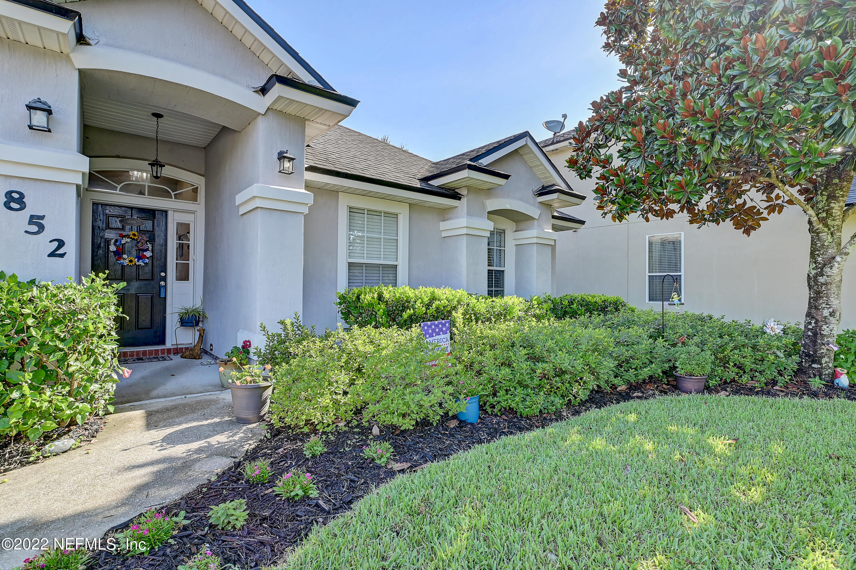 852 Crystal Spring Way St. Augustine, FL 32092 - Photo 3 of 28 a front view of a house with garden