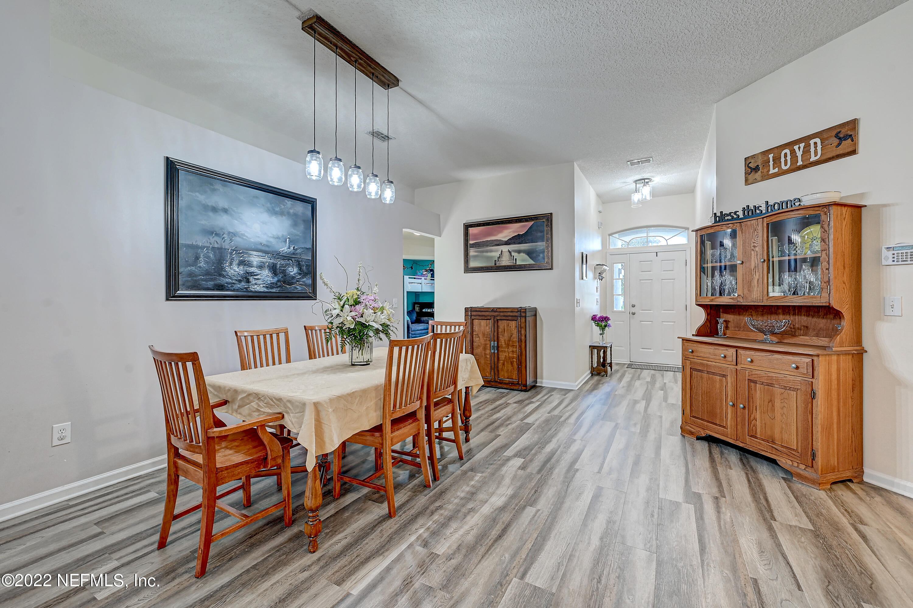852 Crystal Spring Way St. Augustine, FL 32092 - Photo 6 of 28 a view of a dining room with furniture a chandelier and wooden floor