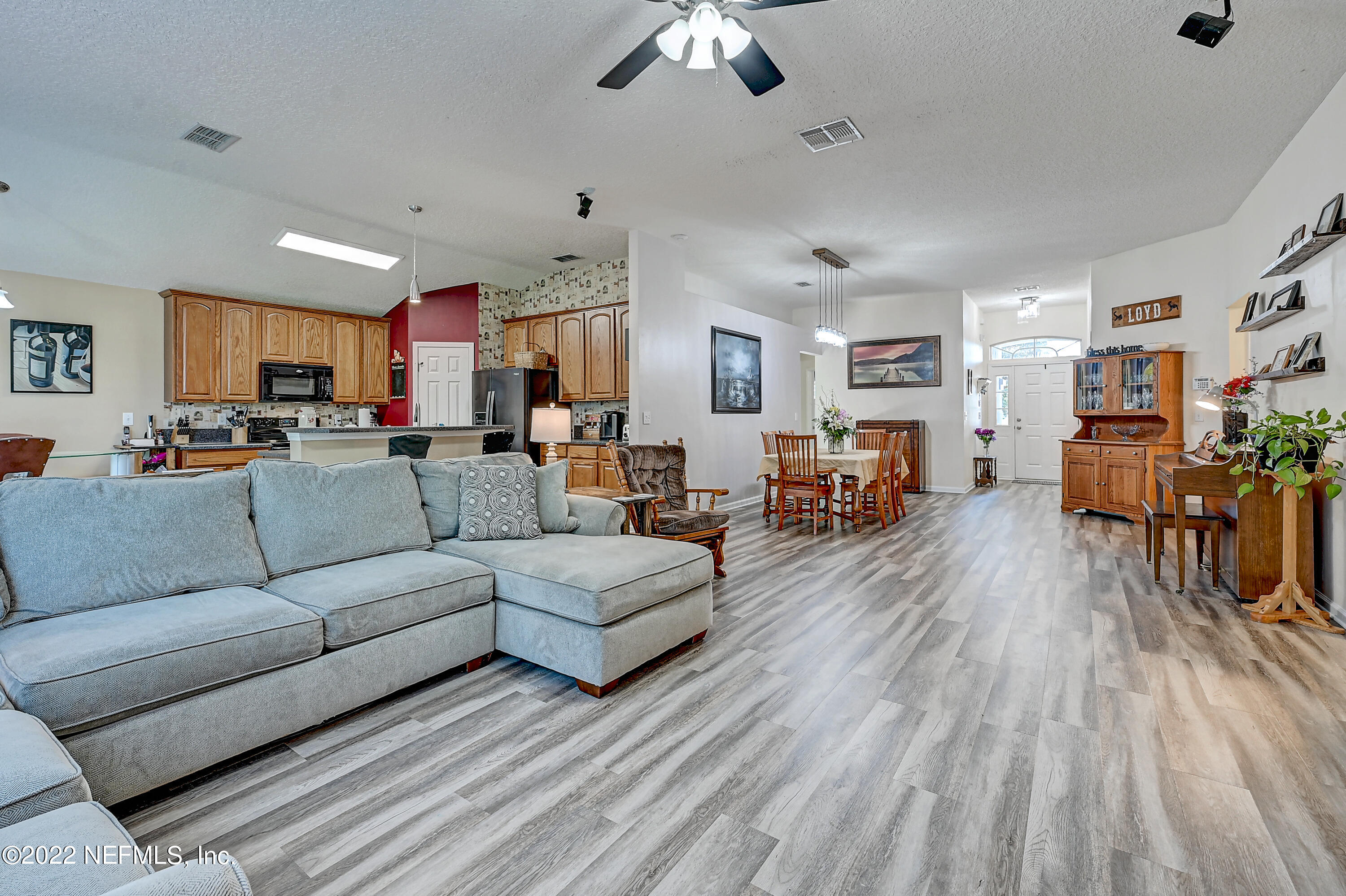 852 Crystal Spring Way St. Augustine, FL 32092 - Photo 8 of 28 a living room with furniture and a wooden floor
