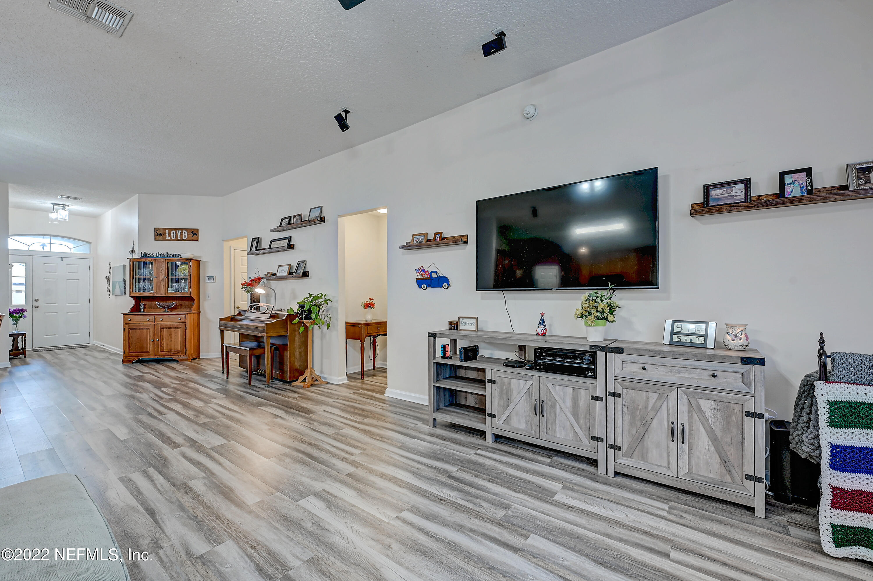 852 Crystal Spring Way St. Augustine, FL 32092 - Photo 9 of 28 a living room with furniture and a flat screen tv