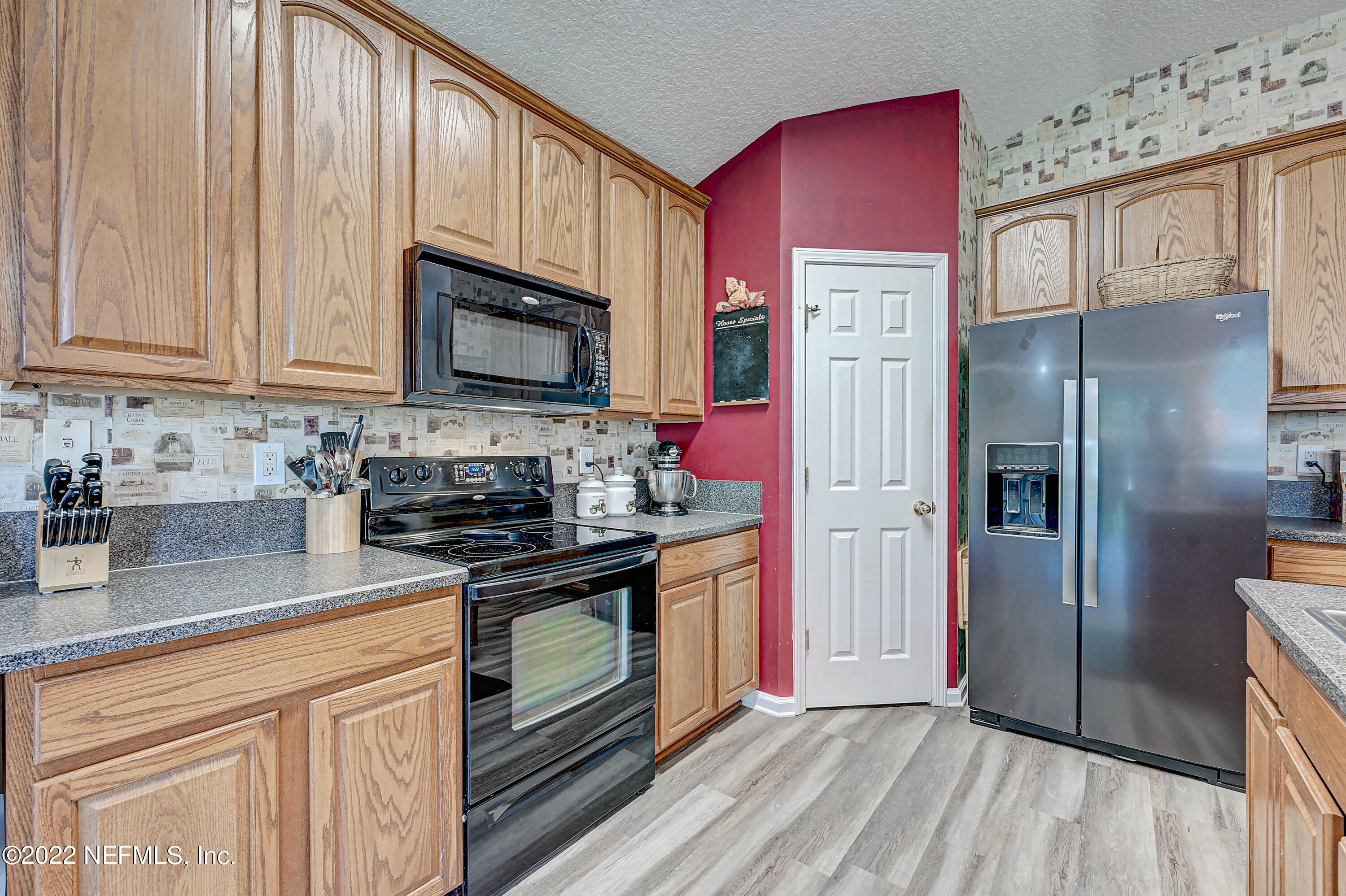 852 Crystal Spring Way St. Augustine, FL 32092 - Photo 10 of 28 a kitchen with stainless steel appliances granite countertop a stove a refrigerator and cabinets